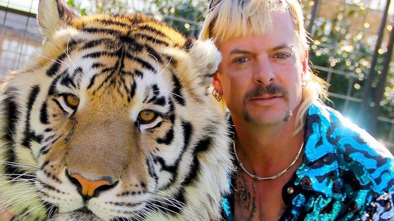 Joe Exotic posa com um tigre em cena de A Máfia dos Tigres, da Netflix - Reprodução/Netflix