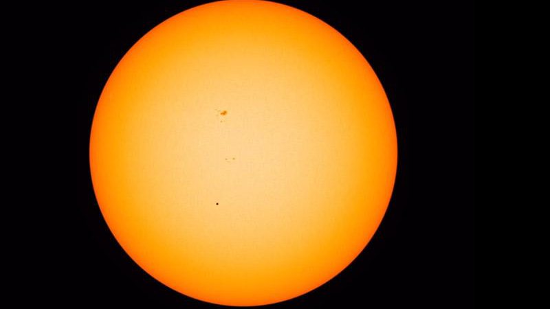 Mercúrio (o ponto preto pequenino no centro da foto) passou entre o Sol e a Terra na última segunda-feira (9/5) - Foto: NASA
